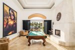 Play pool in the glamorous game room with backyard views